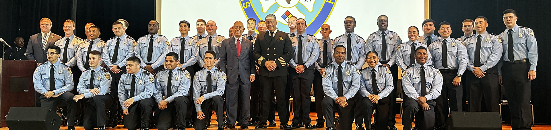 Graduating Class of Cadets on Stage with Fire Chief